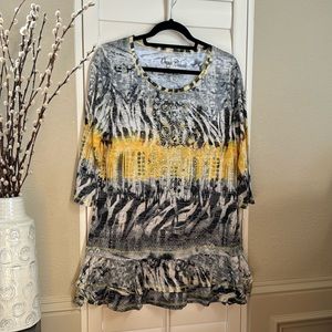 Really fun top, beads and sequences decorate the front. Light airy fabric.